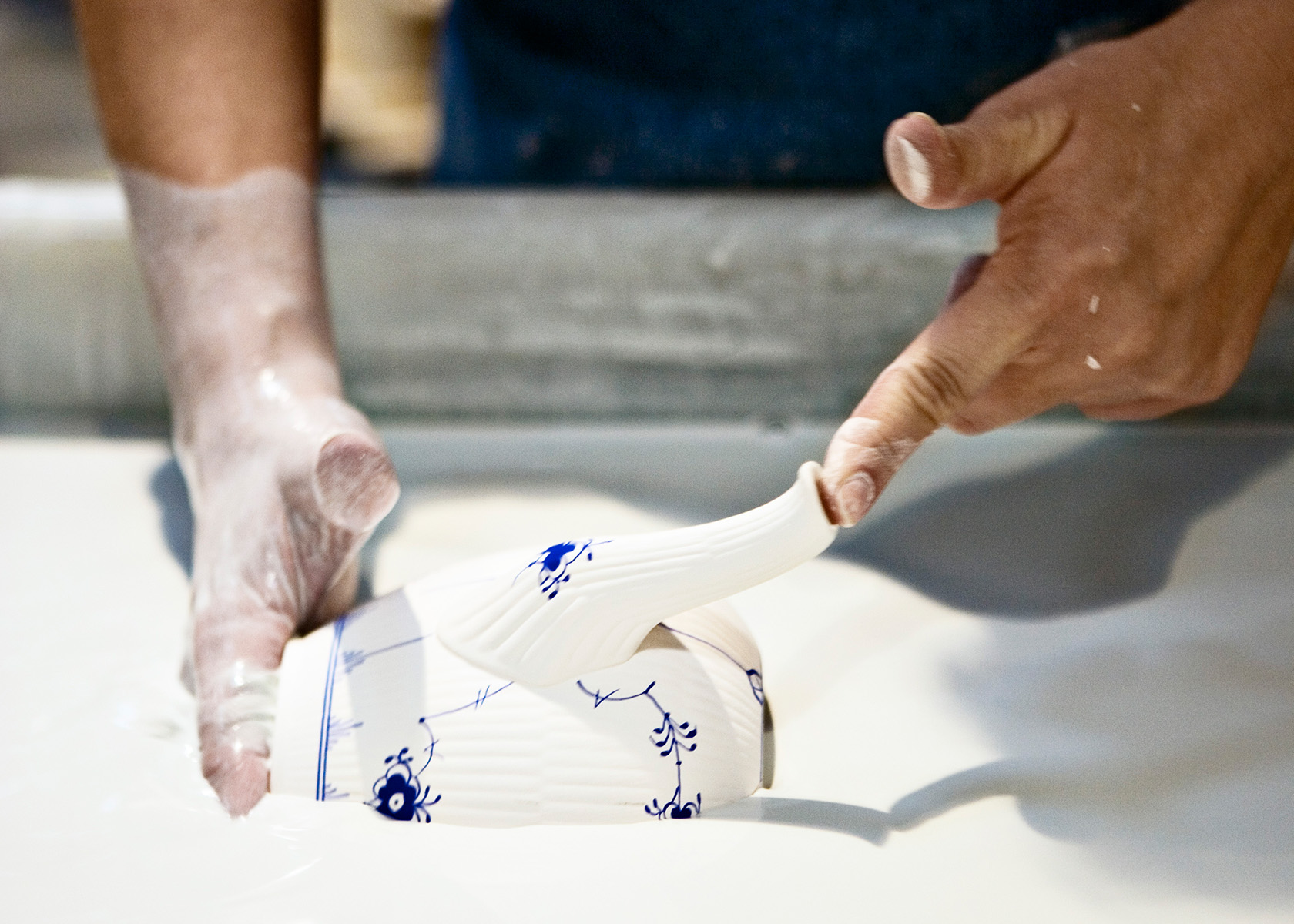 Hand glazing a Royal Copenhagen Teapot